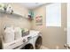 Efficient laundry room featuring modern Samsung washer and dryer with storage shelf and decor at 12845 Park Creek Way Way, Firestone, CO 80504