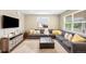 Comfortable living room with a large sectional sofa, plush rug, and entertainment center at 12845 Park Creek Way Way, Firestone, CO 80504