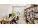 Functional home office featuring a spacious desk, shelving, and natural light for a productive workspace at 12845 Park Creek Way Way, Firestone, CO 80504