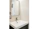 Bright bathroom featuring a modern vanity, chrome faucet, and a stylishly framed mirror at 190 S Canosa Ct, Denver, CO 80219