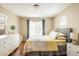 Cozy bedroom features wood floors, a gray headboard and a floral quilt at 190 S Canosa Ct, Denver, CO 80219