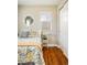 Comfortable bedroom boasts hardwood floors, and a cozy floral-themed bedding at 190 S Canosa Ct, Denver, CO 80219
