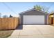 Detached two-car garage with a white door and a private fenced driveway at 190 S Canosa Ct, Denver, CO 80219