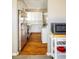 Modern kitchen with stainless steel appliances and white cabinets, flowing into dining area at 190 S Canosa Ct, Denver, CO 80219
