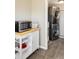 Convenient laundry area features stacked washer/dryer and storage cart with microwave at 190 S Canosa Ct, Denver, CO 80219