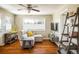 Cozy living room with hardwood floors, a sectional sofa, and natural light at 190 S Canosa Ct, Denver, CO 80219