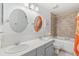 Bathroom featuring double sinks, decorative mirrors, and a shower and bathtub combination at 6340 E Costilla Pl, Centennial, CO 80112