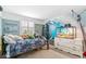 Bright bedroom with a wave-themed mural, reptile habitat, and playful stuffed animals for a unique touch at 6340 E Costilla Pl, Centennial, CO 80112