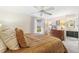 Inviting bedroom with a ceiling fan, a large window, and access to an ensuite bathroom at 6340 E Costilla Pl, Centennial, CO 80112