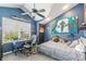 Blue bedroom featuring a desk, ceiling fan, and sports decor for a vibrant and personalized space at 6340 E Costilla Pl, Centennial, CO 80112