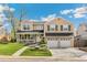 Charming two-story home featuring a welcoming front porch, attached two car garage, and manicured lawn at 6340 E Costilla Pl, Centennial, CO 80112