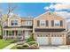 Inviting two-story home with a covered porch, two-car garage, and well-maintained landscaping at 6340 E Costilla Pl, Centennial, CO 80112