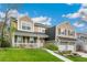 Charming two-story home featuring a covered porch, two-car garage, and well-manicured lawn in a suburban neighborhood at 6340 E Costilla Pl, Centennial, CO 80112