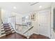 Upstairs hallway features wood floors, access to bedrooms, and decorative wall hangings at 6340 E Costilla Pl, Centennial, CO 80112