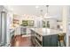 Bright kitchen with island seating, marble counters, stainless appliances, and a view outside at 6340 E Costilla Pl, Centennial, CO 80112