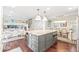 Bright kitchen with a large island, hardwood floors, and adjacent dining area at 6340 E Costilla Pl, Centennial, CO 80112