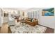 Comfortable living room featuring a sofa, bay window, and a patterned rug at 6340 E Costilla Pl, Centennial, CO 80112