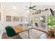 A bright living room with a ceiling fan, a gray sofa, and French doors leading to a balcony at 6340 E Costilla Pl, Centennial, CO 80112