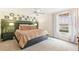 Comfortable bedroom with a large bed, a green accent wall, and a view of the outdoors at 6340 E Costilla Pl, Centennial, CO 80112