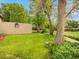 Grassy backyard with mature trees and an enclosed fence at 3914 E 116Th Pl, Thornton, CO 80233
