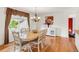 Dining room with hardwood floors, chandelier, and a large window providing natural light at 3914 E 116Th Pl, Thornton, CO 80233