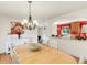 Dining room with hardwood floors, chandelier, and an open floor plan at 3914 E 116Th Pl, Thornton, CO 80233