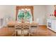 Dining room with hardwood floors, chandelier, and a large window providing natural light at 3914 E 116Th Pl, Thornton, CO 80233