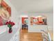 Open floor plan between dining room and kitchen with hardwood floors and bright natural light at 3914 E 116Th Pl, Thornton, CO 80233