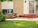 Close up of home's brick and vinyl exterior, decorative security door, and a small yard fountain at 3914 E 116Th Pl, Thornton, CO 80233
