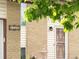 Close up of home's brick and vinyl exterior, decorative security door, and a small yard fountain at 3914 E 116Th Pl, Thornton, CO 80233