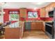 Kitchen showcasing wood cabinets, and counters, with a view of the dining area and natural light streaming in at 3914 E 116Th Pl, Thornton, CO 80233