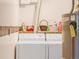 Efficient laundry room with washer, dryer and functional shelving at 3914 E 116Th Pl, Thornton, CO 80233