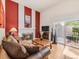 Inviting living room with a fireplace, wood floors, and a view of the patio through sliding glass doors at 3914 E 116Th Pl, Thornton, CO 80233