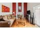 Warm living room with a fireplace, hardwood floors, and comfortable furnishings create an inviting atmosphere at 3914 E 116Th Pl, Thornton, CO 80233