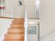 Bright stairway featuring hardwood steps, white banister, and neutral walls with decorative art at 3914 E 116Th Pl, Thornton, CO 80233