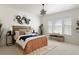 Neutral bedroom featuring natural light, white walls, a decorative star chandelier, and a seating bench at 19834 W 56Th Pl, Golden, CO 80403