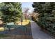 Inviting community park with green benches and walking path, offering residents a peaceful outdoor space at 19834 W 56Th Pl, Golden, CO 80403