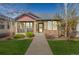 Beautiful home with stone accents, a covered porch, and a well-maintained walkway at 19834 W 56Th Pl, Golden, CO 80403