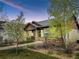 Inviting home showcasing a cozy porch, stone pillars, and mature trees in the front yard at 19834 W 56Th Pl, Golden, CO 80403