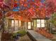 Inviting single-story home featuring a stone facade, covered porch, and manicured landscaping at 19834 W 56Th Pl, Golden, CO 80403
