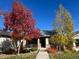 Attractive home featuring vibrant fall foliage, stone accents, and a well-maintained front yard at 19834 W 56Th Pl, Golden, CO 80403
