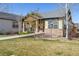 Lovely home with a lush green lawn, stone detailing, and an inviting walkway to the front door at 19834 W 56Th Pl, Golden, CO 80403
