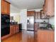 Spacious kitchen with dark cabinetry, stainless steel appliances, and hardwood floors at 19834 W 56Th Pl, Golden, CO 80403