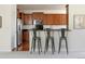 Modern kitchen with dark cabinets, granite counters, and stainless steel appliances at 19834 W 56Th Pl, Golden, CO 80403