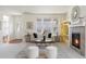 Bright living room features a fireplace, large windows, and stylish decor at 19834 W 56Th Pl, Golden, CO 80403