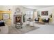 Bright living room features a fireplace, neutral color palette and large windows at 19834 W 56Th Pl, Golden, CO 80403