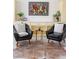 Elegant sitting area with leather chairs, decorative rug, and ample storage at 19834 W 56Th Pl, Golden, CO 80403