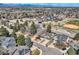 Expansive aerial view showcases the neighborhood, nearby school, and mountain views at 6651 Yale Dr, Highlands Ranch, CO 80130