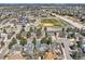 Neighborhood aerial view featuring lush greenery, nearby school, and open athletic field at 6651 Yale Dr, Highlands Ranch, CO 80130