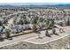 Aerial view showcasing the neighborhood with well-maintained houses, mature trees, and the surrounding landscape at 6651 Yale Dr, Highlands Ranch, CO 80130